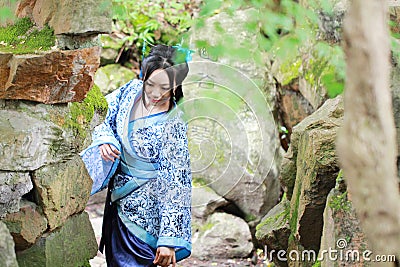 Asian Chinese woman in traditional Blue and white Hanfu dress, play in a famous garden Stock Photo