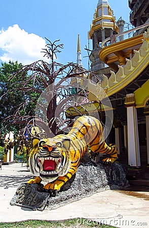 Asian colorful tiger statue at the entrance to the temple Stock Photo