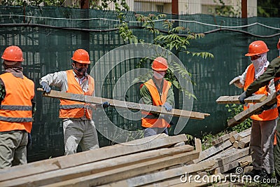 Asian construction workers on a construction site in Bucharest Editorial Stock Photo