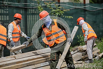 Asian construction workers on a construction site in Bucharest Editorial Stock Photo