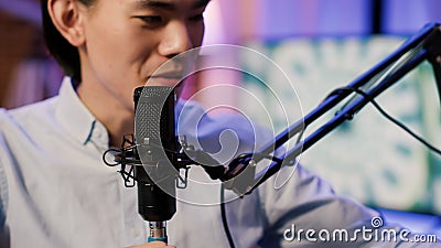 Asian content creator recording podcast chat with microphone Stock Photo