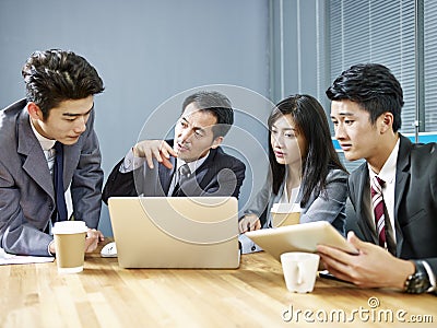 Asian corporate people discussing business in meeting Stock Photo