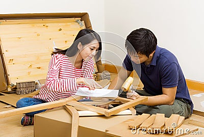 Asian couple assembling new furniture Stock Photo