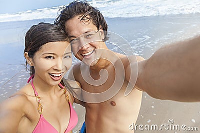 Asian Couple at Beach Taking Selfie Photograph Stock Photo