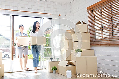 Asian couple buy a new house, hold a paper box to put things in. Stock Photo