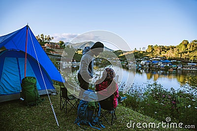 Asian couple Camp on the mountain in the upper village near the lake, Camping Travel Concept,Travel Relax concept Map Stock Photo