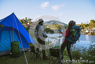 Asian couple Camp on the mountain in the upper village near the lake, Camping Travel Concept,Travel Relax concept Map Stock Photo