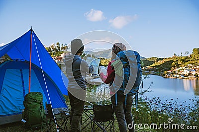 Asian couple Camp on the mountain in the upper village near the lake, Camping Travel Concept,Travel Relax concept Map Stock Photo
