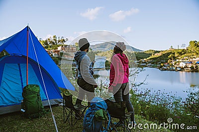 Asian couple Camp on the mountain in the upper village near the lake, Camping Travel Concept,Travel Relax concept Map Stock Photo