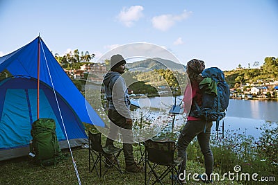 Asian couple Camp on the mountain in the upper village near the lake, Camping Travel Concept,Travel Relax concept Map Stock Photo