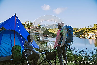 Asian couple Camp on the mountain in the upper village near the lake, Camping Travel Concept,Travel Relax concept Map Stock Photo