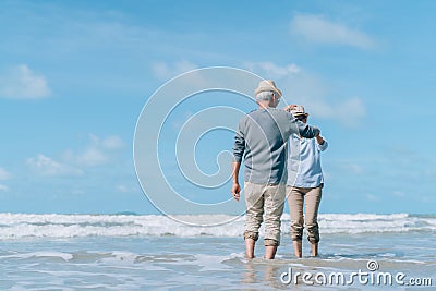 Asian couple senior elder dancing retirement resting relax at sunset beach honeymoon Stock Photo