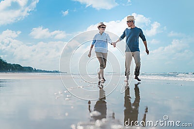 Asian couple senior elder retire resting relax walking running at sunset beach honeymoon Stock Photo