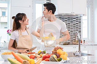 Asian couples feeding food together in kitchen. People and lifestyles concept. Sweet honeymoon and Holidays concept. Valentines d Stock Photo