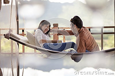 Asian couples relaxing vacation time on cradle Stock Photo