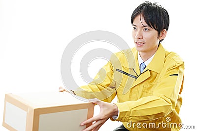 Asian courier delivering a package Stock Photo