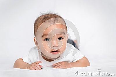 asian cute baby boy on white bed in Stock Photo