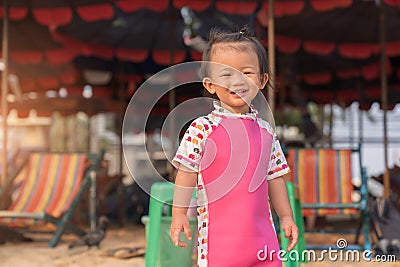 Asian cute baby girl smiling on the beach background. Stock Photo