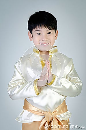 Asian cute boy in thai costume acting Hello Stock Photo