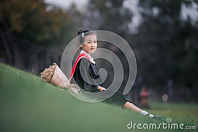 Asian cute child girl graduate. Girl smile on graduation kindergarten uniform Stock Photo