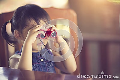 Asian cute little girl binoculars toy Stock Photo