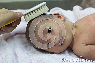 Asian cute new born baby comb hair. Stock Photo