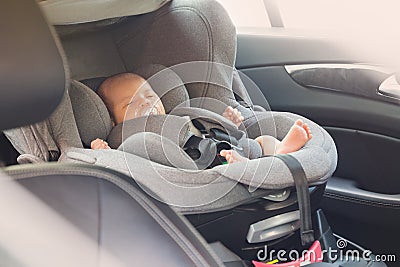 Asian cute newborn baby sleeping in modern car seat. Stock Photo