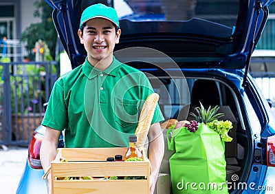 Asian delivery man in green t-shirt delivering food Stock Photo