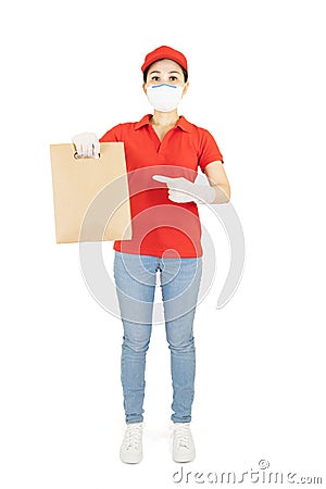 Asian Delivery woman in red uniform isolated on white background.Courier in protective mask and medical gloves delivers takeaway Stock Photo