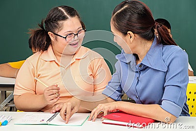 Asian disabled children Or, an autistic child learns to read, write and train their hand and finger muscles with a teacher at Stock Photo