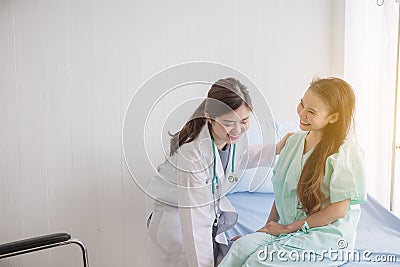 Asian doctor support to her patients woman in hospital,Healthcare concept,Happy and smiling Stock Photo