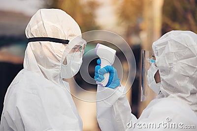 Asian doctor wearing ppe suit and face mask in hospital or outside. Protection from covid-19 and coronavirus pandemic Stock Photo