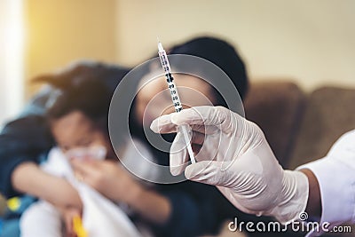 Asian doctors are checking syringes to treat children. Stock Photo