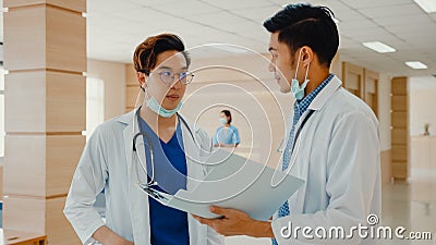 Asian doctors talk and discuss about patient`s case in hospital. Asia men medical practitioner consult patient case, Stock Photo