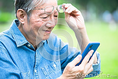Asian elder man has presbyopia Stock Photo