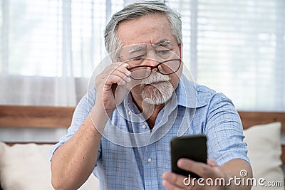 Asia elderly man who has eye pain and poor vision, Long sighted, Glaucoma. Stock Photo