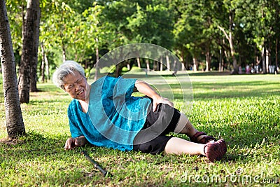 Asian elderly people with walking stick on floor after falling down in summer outdoor park,sick senior woman fell to the floor Stock Photo