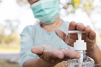 Asian elderly people wearing protective mask,using alcohol antiseptic gel,prevent infection,outbreak of Covid-19,senior woman Stock Photo