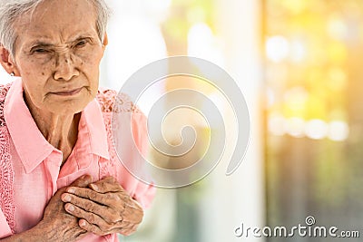 Asian elderly woman with certain symptoms,difficulty breathing,suffering or heart problems,Communicates the symptoms of heart Stock Photo
