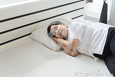 Asian elderly woman sleeping happy on bed and smiling her hands beside her head,Good dream,Daydream Stock Photo