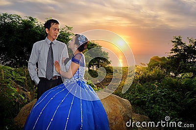 Asian elegance wedding couple ourdoor with sunset backgound Stock Photo