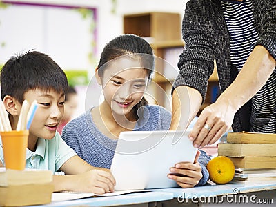 Asian elementary schoolchildren using digital tablet Stock Photo