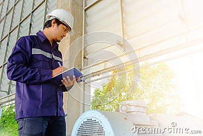 Asian engineer or technician in blue collar safety uniform and w Stock Photo