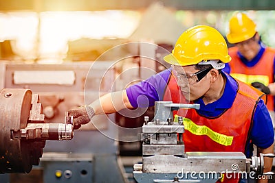 Asian engineer worker using Vernier Caliper to check size for accuracy precision quality control of service machine in factory Stock Photo