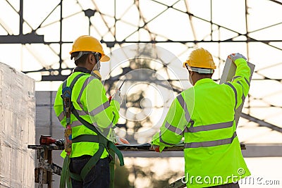 Asian engineers and consultant workers calculate the amount of bricks used in construction, Concept of construction team work Stock Photo