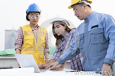 Asian engineers were consulted together and plan in construction Stock Photo