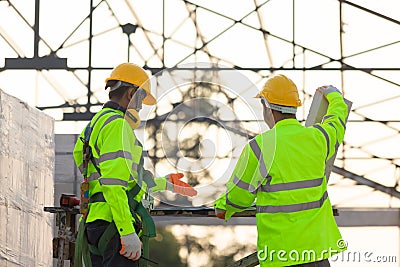 Asian engineers and workers consulted together for construction planning and development background is the structure of the roof, Stock Photo