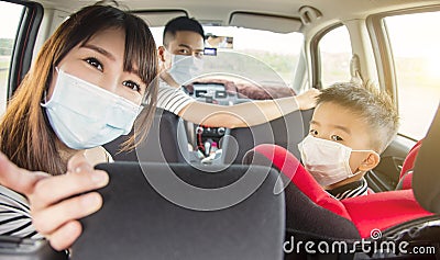 Asian family with children rides in their car and wear medical masks Stock Photo