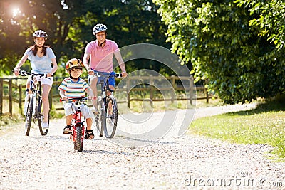 Asian Family On Cycle Ride In Countryside Stock Photo