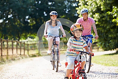 Asian Family On Cycle Ride In Countryside Stock Photo